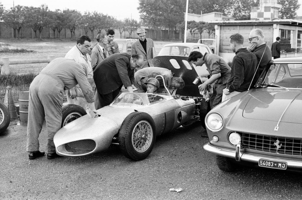 1961 Ferrari testing phil hill standing with enzo ferrari